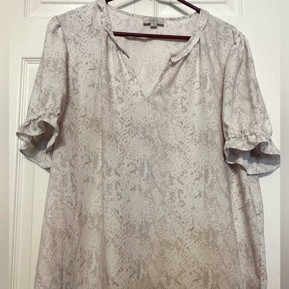 Loft blouse with ruffled elastic sleeves and V neck. Colors are pink and white.